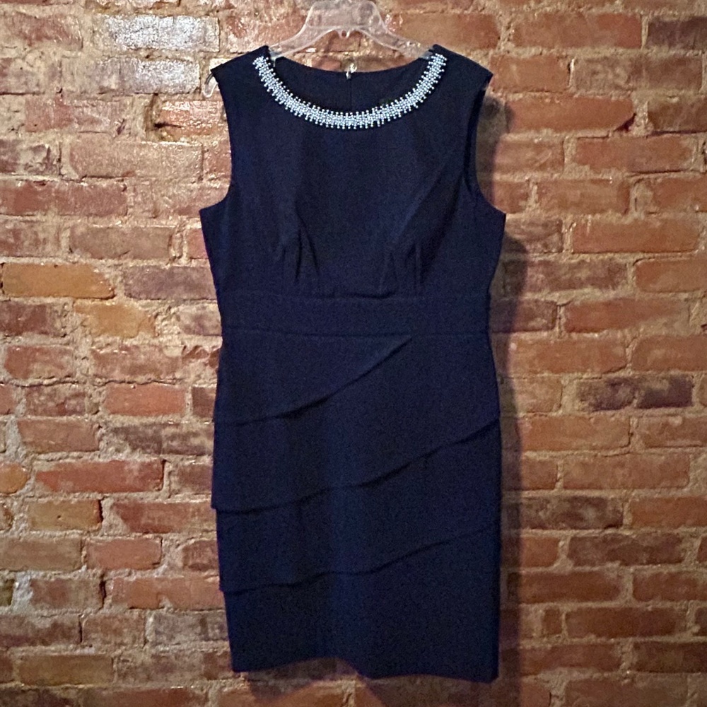 Faux Pearl neckline, Sleeveless Empire waist with Cascading front panels…